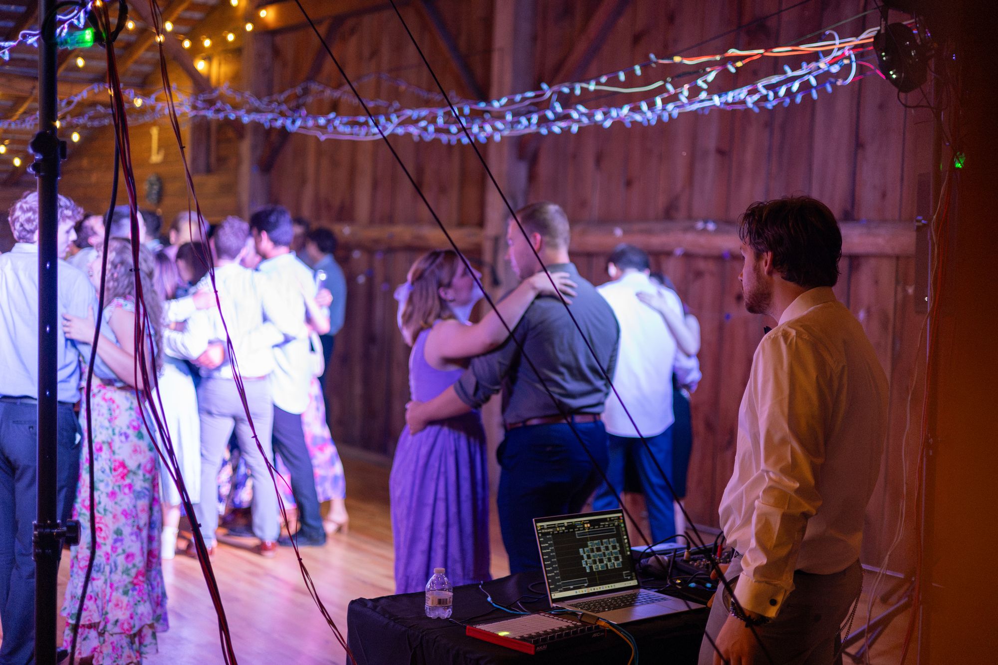 Couples slow dancing under the lit canopy